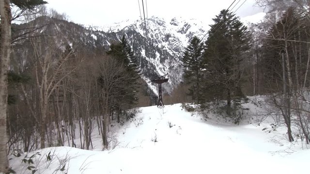 POV Shot : Cable cabin over snow mountain . Shinhotaka Ropeway, Cable car station, Takayama Gifu, Japan