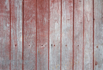 vertical row of faded red painted hardwood panel floor texture background