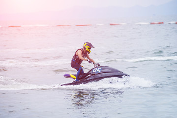 Fototapeta na wymiar Young guy riding on the jet ski in gulf of Siam