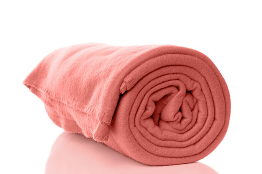 rolled up fleece blanket in living coral - color of the year 2019