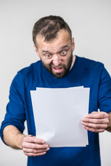 Shocked man looking at documents