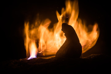 Horror silhouette of scary figure at night. Female demon. Demons coming. Slhouette of devil or monster figure on a background of fire.
