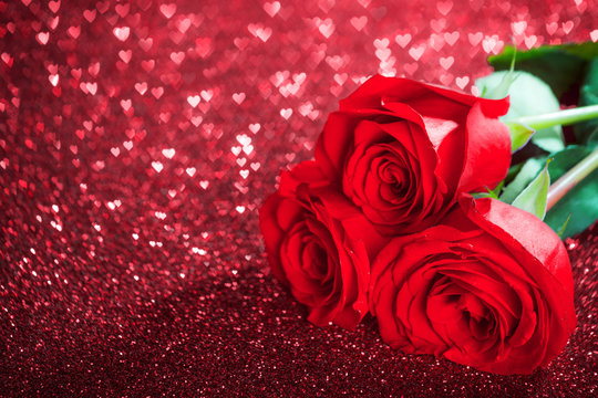 Red rose flowers and glitter hearts
