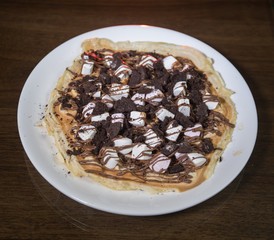 Sweet cheesecake in glass on a table with toned foggy backglight.