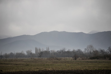 Fototapeta premium Panorama of the foggy winter landscape in the mountains with snow and rocks, Beautiful landscape of winter nature of Azerbaijan