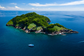 Aerial drone view of a remote, beautiful tropical island surrounded by coral reef (Ko Bon, Thailand)