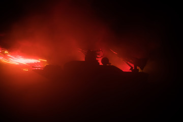 Sea battle scene. Silhouette of military war ship on dark foggy toned sky background. Explosion and...
