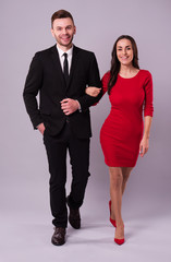 Love you so much! Beautiful stylish and elegant couple in suit and dress are hugging, have a fun and posing isolated in studio. Holidays and events. St Valentine's day. Day of lovers