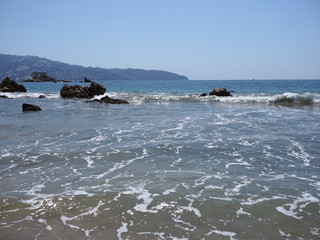 Wonderful view of rocks at bay of ACAPULCO city in Mexico with Pacific Ocean waves on sandy beach...
