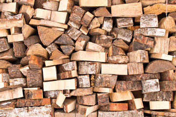 The background texture of a large pile of wood. Close up