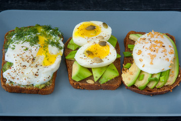 Sandwiches with avocado and egg on a plate.