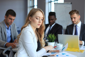 business woman with her staff, people group in background at modern bright office indoors.