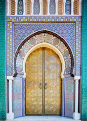 Entrance door with mosaic and brass door at the Royal palace in Fez Morocco