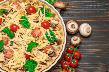 Traditional quiche tart in baking form with filling