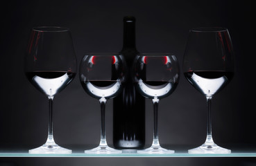 Glasses and bottle of red wine.