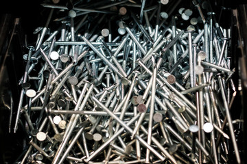 Metal nails. arranged in a dark colored spot. shallow depth of cut.