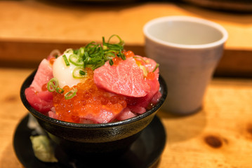 Bowl of fresh sashimi, salmon roe and egg at a Japanese restaurant