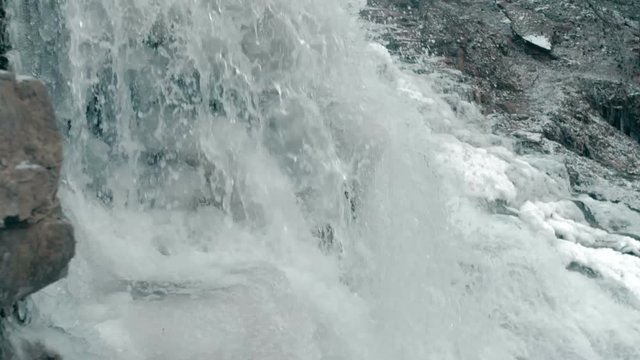 Close up slow motion waterfall water splash. Nature background footage.