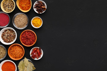 Dried spices and fresh seasoning in spoons and bowls