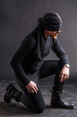 Portrait of a masked super hero on black background.