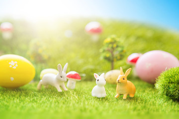 Easter rabbits on green grass with Easter eggs in Dreamland or fairy world easter cute grass
