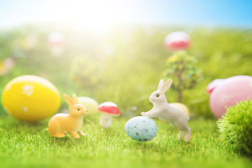 Easter rabbits on green grass with Easter eggs in Dreamland or fairy world