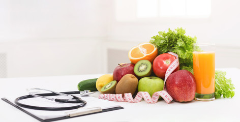 Nutritionist desk with healthy fruit and stethoscope