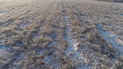 aerial view winter landscape flight over snow covered field in winter. Snow covered farmland during winter