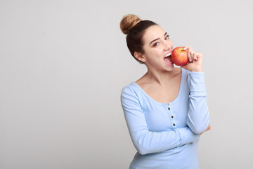 Healthy eating. Pretty girl biting fresh apple