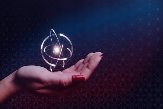 Human hand holding atom. Nebula dust. Mixed media.