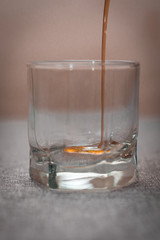 the glass is filled with dark liquid on a gray background