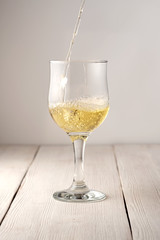 Glass of white wine on vintage wooden table
