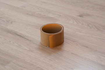 Brown adhesive tape on wood laminate background