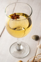 Glass of white wine on vintage wooden table. marine theme