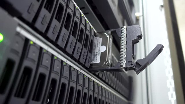 IT Engineer install hard drive in server rack. Cluster Server Data Room. Detailed and Technically Accurate Footage close up. Concept 3.0. The video contains flicker. 