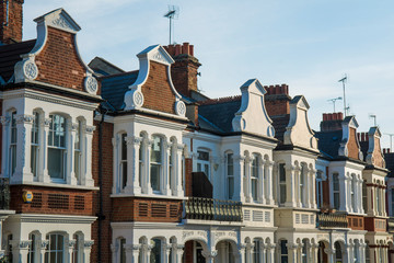 Row of typical British red brick terraced houses