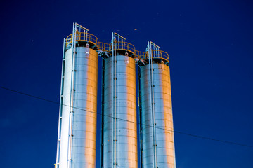 industrial tanks in factory at night