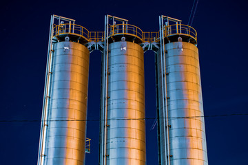 industrial tanks in factory at night