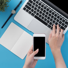 Social network connecting office table concept with fashion accessories, minimal interior with a woman holding smartphone, top view, flat lay, mockup, copy space