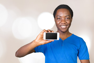 Cheerful African teenager showing his mobile phone