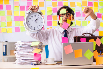 Young employee in conflicting priorities concept 