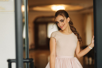 Beautiful stunning young lady in amazing dress sitting on luxury armchair