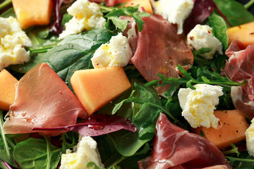 Parma ham and melon salad with mozzarella, green leaves mix