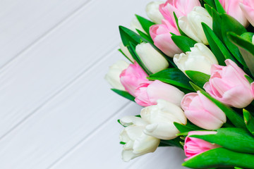 Tulips on wooden background. Bunch of flowers. Bouquet for love. Holiday card with copy space.