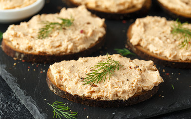 Fresh homemade smoked salmon pate on brown bread toast with dill