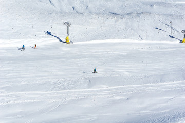 A skier is skiing on snow at a ski resort in the mountains. Winter landscape