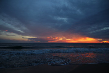 Wave art in the water's edge after sunset in the twiglight in summertime