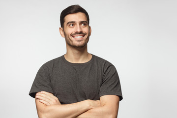 Portrait of positive Europen man pictured isolated on gray background