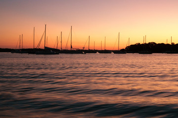 Fototapeta na wymiar Florida peaceful sunset with sailboats in harbor