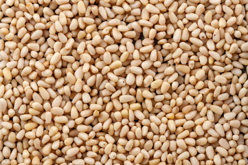 Background made of peeled pine nuts.